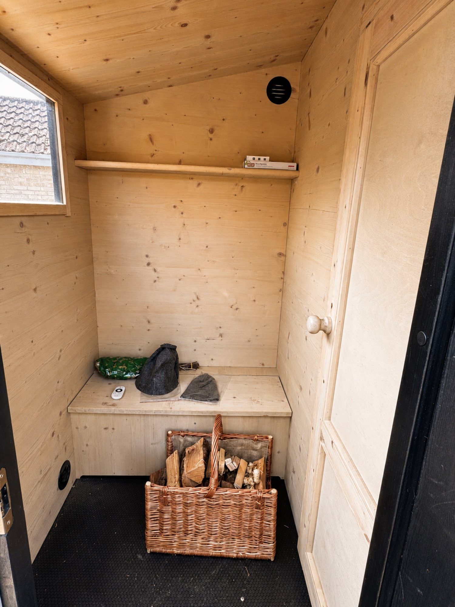 Proper Finnish Sauna carousel - actual changing room and included starter firewood Actual changing room inside Lapland Mobile Sauna with sauna hats and the included starter firewood