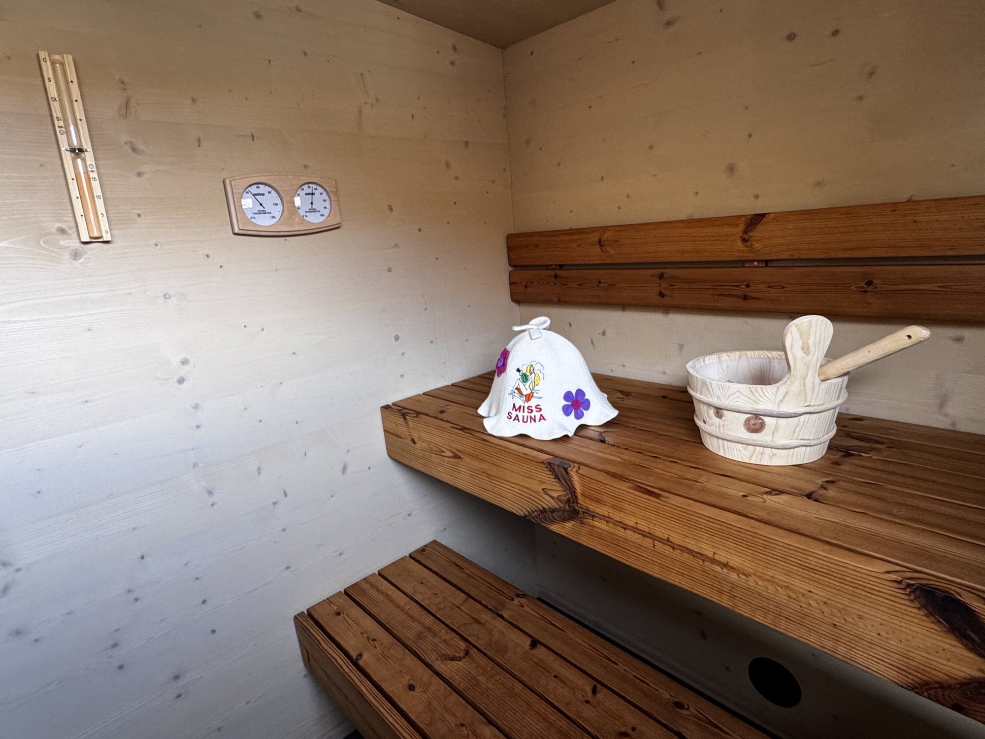 Proper Finnish Sauna carousel - actual interior and accessories Actual sauna room with timber benches, sauna hat and the real water bucket and ladle
